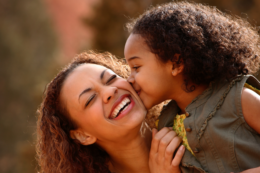 child therapy image, little girl kisses mother