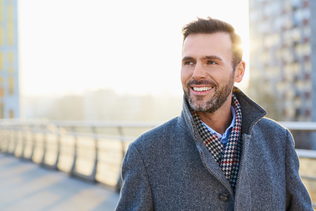 adult therapy image, man in coat on bridge