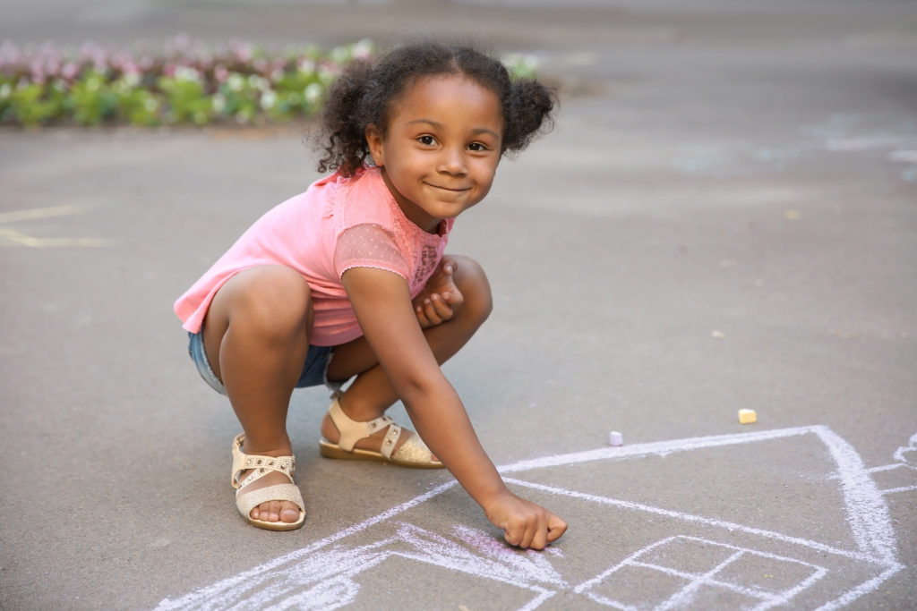 child therapy image, girl playing with chalk
