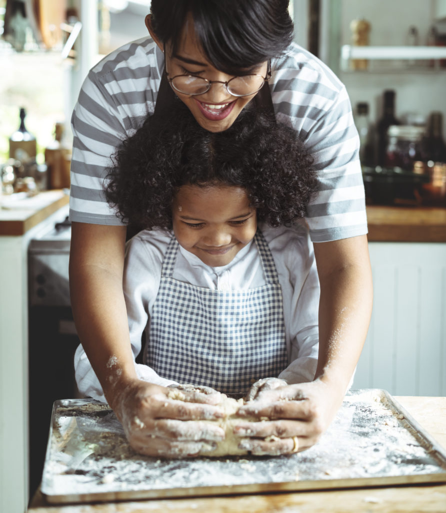 Family First VA homepage photo: Parent teaching child to bake