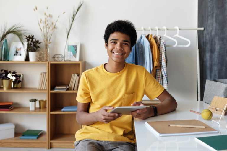 teen therapy image, teen boy holding tablet