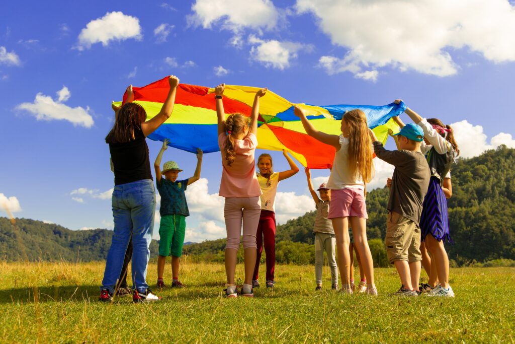 Warm family moment with parents and children playing outdoors